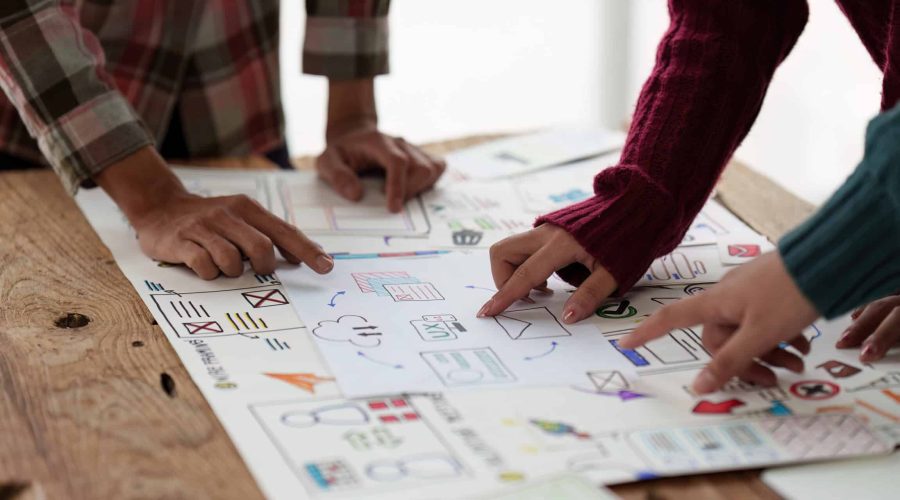 Close up ux developer and ui designer brainstorming interface wireframe design.Creative digital development agency marketing journey