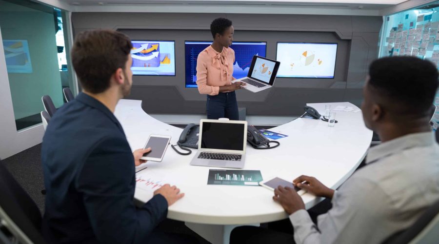 Male and female executives discussing over graph in boardroom enterprise seo