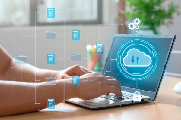 A man utilizes cloud computing technology on his laptop for data transmission, storage, backup, and retrieval seo migrations