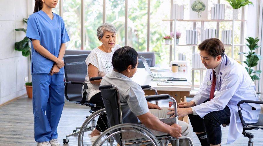 Senior couple male on wheel chair having consultations with doctor for knee problems at clinic health care