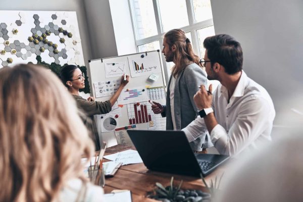 Team of innovators. Modern young man and woman conducting a business presentation while working in the office marketing strategy