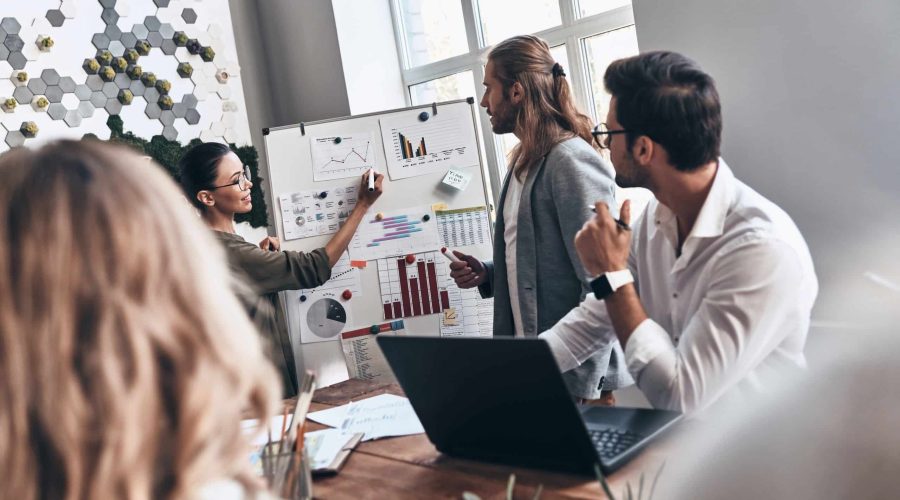 Team of innovators. Modern young man and woman conducting a business presentation while working in the office marketing strategy