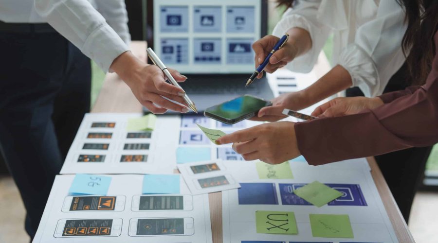 Web designers working on user experience and user interface of mobile application Custom Solutions