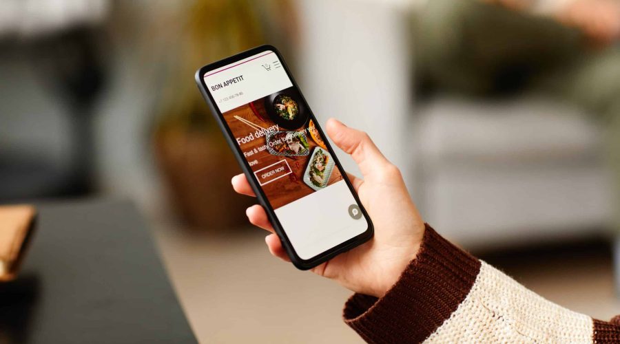 Woman ordering food online on phone software